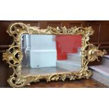 Giltwood reproduction mirror with floral and scroll decoration