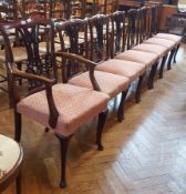 Set of seven mahogany Chippendale style dining chairs with pink and gold shield pattern cushions,