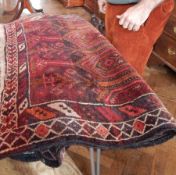 Persian style wool rug decorated with pointed arch panels, on red ground, geometric borders,