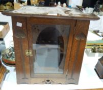 Early twentieth century Art Nouveau style carved oak table top cigar cabinet with central glass