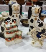 Pair Staffordshire pottery spaniels in black and white with gilt highlights,