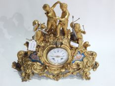 Late 19th century gilt metal mantel clock depicting putti playing instruments and dancing on rocky