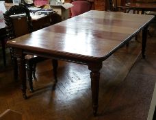 19th century mahogany dining table with three extra leaves, on tapering reeded legs with castors,