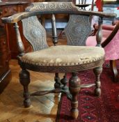 Late 19th century carved walnut corner chair of foliate design, upholstered seat,
