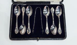 Set of six silver teaspoons with rococo scroll borders and matching sugar nips,