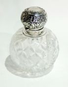 Victorian cut glass scent bottle of circular form with repousse silver mounts of rococo decoration,