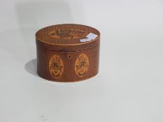 Regency inlaid mahogany oval tea caddy with floral cartouches and having single fitted compartment