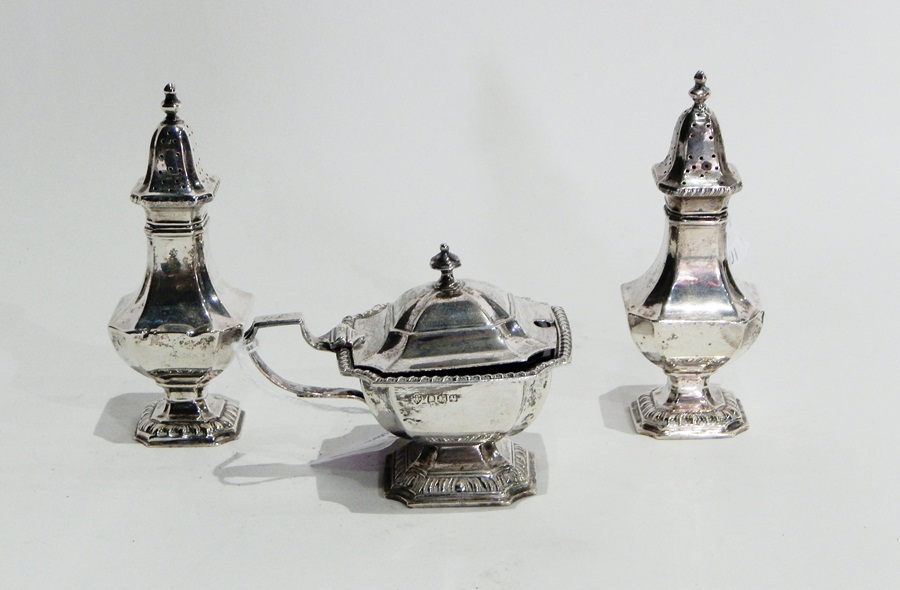 Silver matched cruet set comprising pair of pepperpots and lidded mustard with blue glass liner,