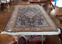 Silk rug, blue ground, floral and foliate decorated in shades of pink, blue and cream,