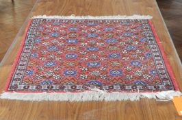 Wool rug, red ground, floral trellis decorated,