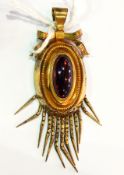 Gold-coloured metal and cabochon garnet stone set locket pendant,