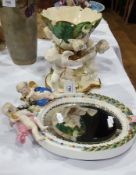 Victorian pottery centrepiece of three putti holding lily leaf and flower decorated raised bowl,