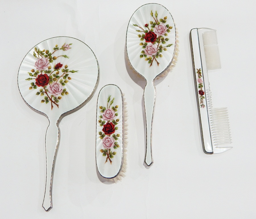 Silver and engine turned enamel dressing table set, rose decorated, comprising hand mirror,