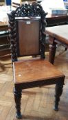 19th century carved walnut hall chair, the crestrail with pierced bird carving,