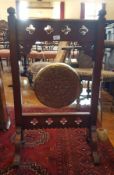 Victorian mahogany framed brass dinner gong of Gothic design, with striker,