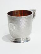 Victorian silver mug with fine stipple work engraving, scroll handle, raised on a circular foot,