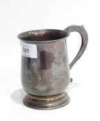 A George V silver christening mug with flared rim and scroll handle, raised on a circular foot,