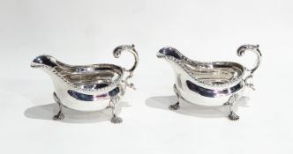 Pair Edwardian George III style sauceboats with gadrooned border, engraved crest above initial "E",