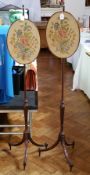 Pair of Georgian mahogany pole screens with oval floral tapestry panels,