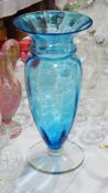 Tall blue glass vase with everted rim, panelled and tapering body,