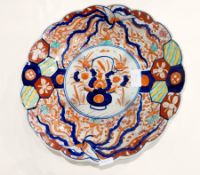 Two similar Japanese porcelain Imari chargers with basket of flowers decoration to the centre,