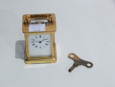 A French carriage clock timepiece in a glazed brass case,