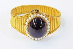 19th century gold-coloured metal cabochon garnet and seedpearl bracelet/locket the large oval