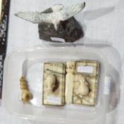 Two little ivory elephants on marble plinth, bone fist,