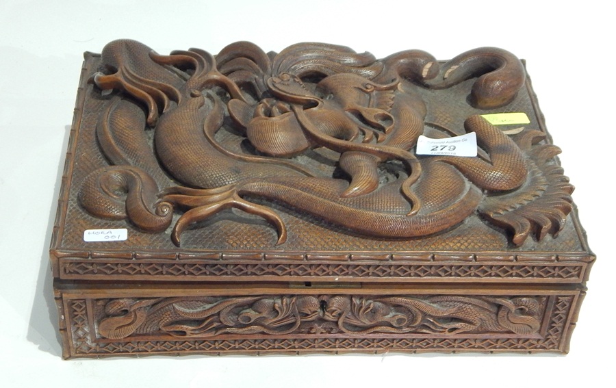 Oriental hardwood cigar box having relief carved dragon to top with similar side panels,