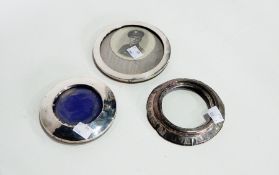 Three silver circular photograph frames together with silver-topped glass hair tidy (4)