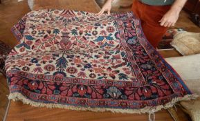 Wool rug, the cream ground decorated with vases of flowers, floral borders,