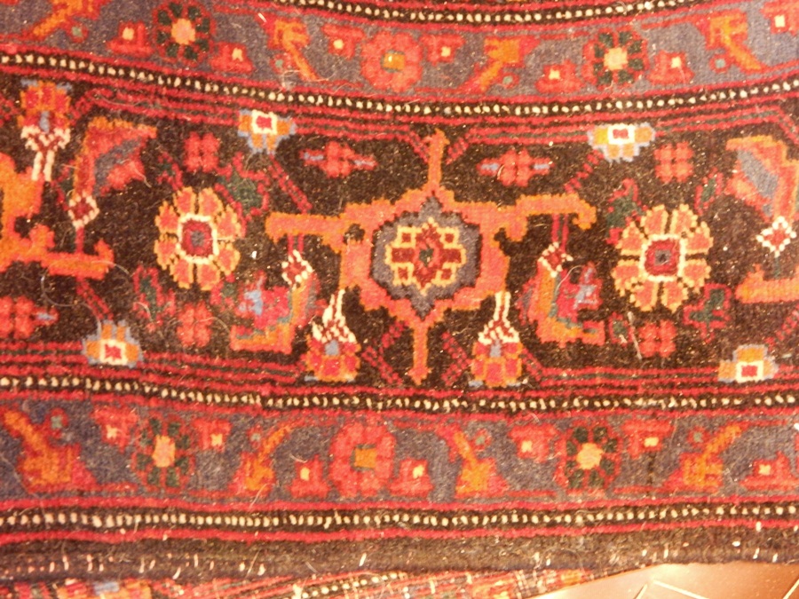 Persian style wool carpet, the red ground with central stepped medallion,