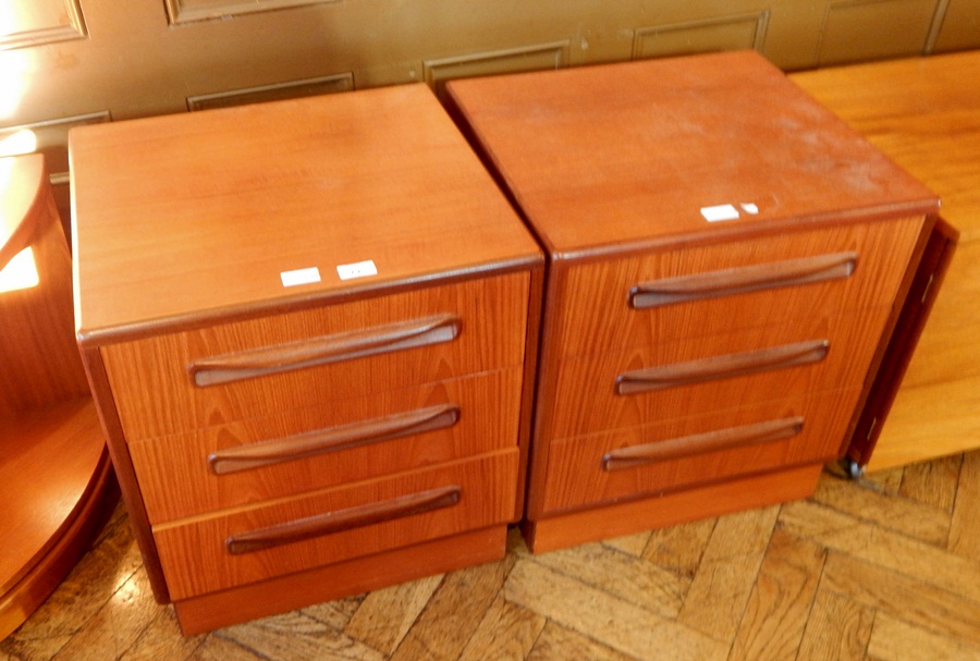 A pair of G-Plan bedside chests, of three short drawers,