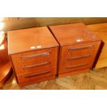 A pair of G-Plan bedside chests, of three short drawers,