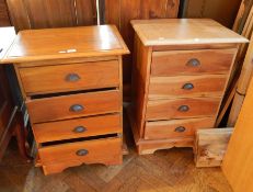 A pair of pine chests of four short drawers raised on bracket feet,