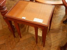 A nest of three modern occasional tables with inset glass tops, 53cm wide,