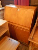 A modern bureau with fitted interior, with cupboard below,