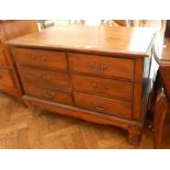 An Eastern hardwood chest of six short drawers raised on short square cabriole legs,