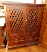 An Eastern hardwood cupboard with open slatwork doors and sides,