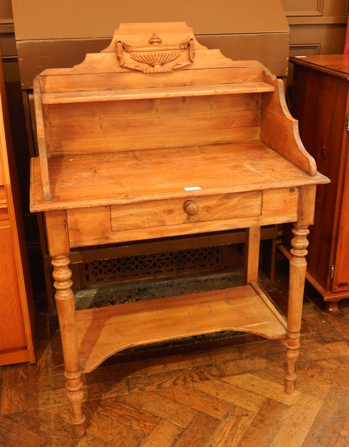 An old pine washstand with open shelf back, frieze drawer on turned tapering legs with undershelf,