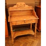 An old pine washstand with open shelf back, frieze drawer on turned tapering legs with undershelf,