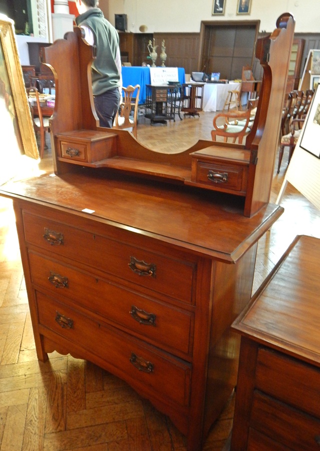 A late Victorian walnut dressing table, the back with open shelf and a pair of trinket drawers,