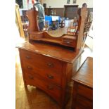 A late Victorian walnut dressing table, the back with open shelf and a pair of trinket drawers,