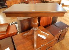 A rectangular top hardwood side table on turned pedestal support with quadruped splayed legs,