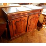 A Victorian mahogany two-door chiffonier having a cushion moulded drawer over two shield panelled