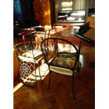 A set of four iron framed conservatory chairs, with rush seats,