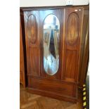 An Edwardian mahogany inset and wood inlaid mirror door wardrobe, the interior with hanging space,