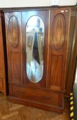 An Edwardian mahogany inset and wood inlaid mirror door wardrobe, the interior with hanging space,