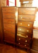 A pair of Eastern hardwood chests of seven short drawers on short cabriole legs,