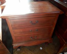 An Eastern hardwood chest of three drawers with moulded edge top, on square cabriole legs,